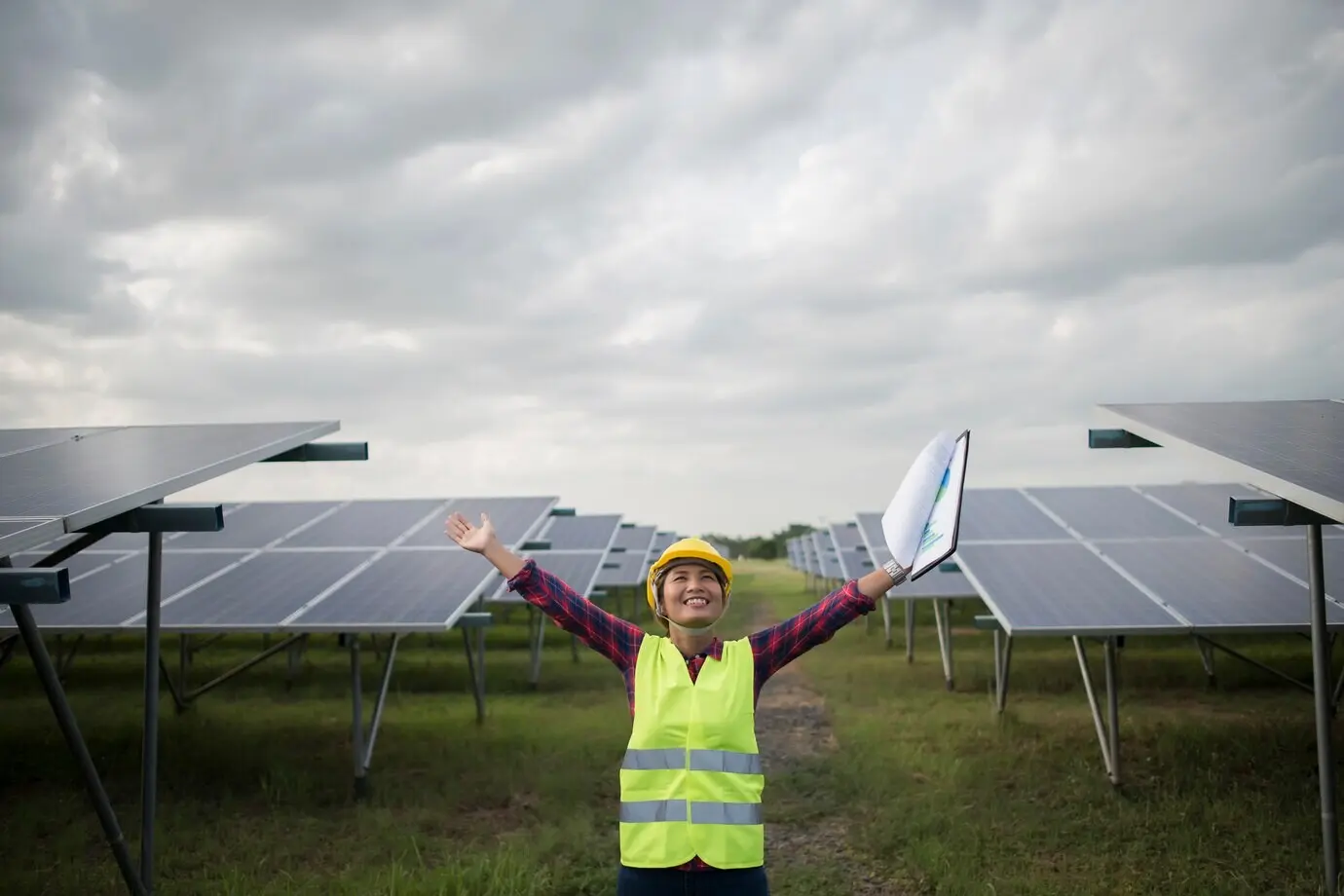 Female electrical engineer inspecting and maintaining solar cells.